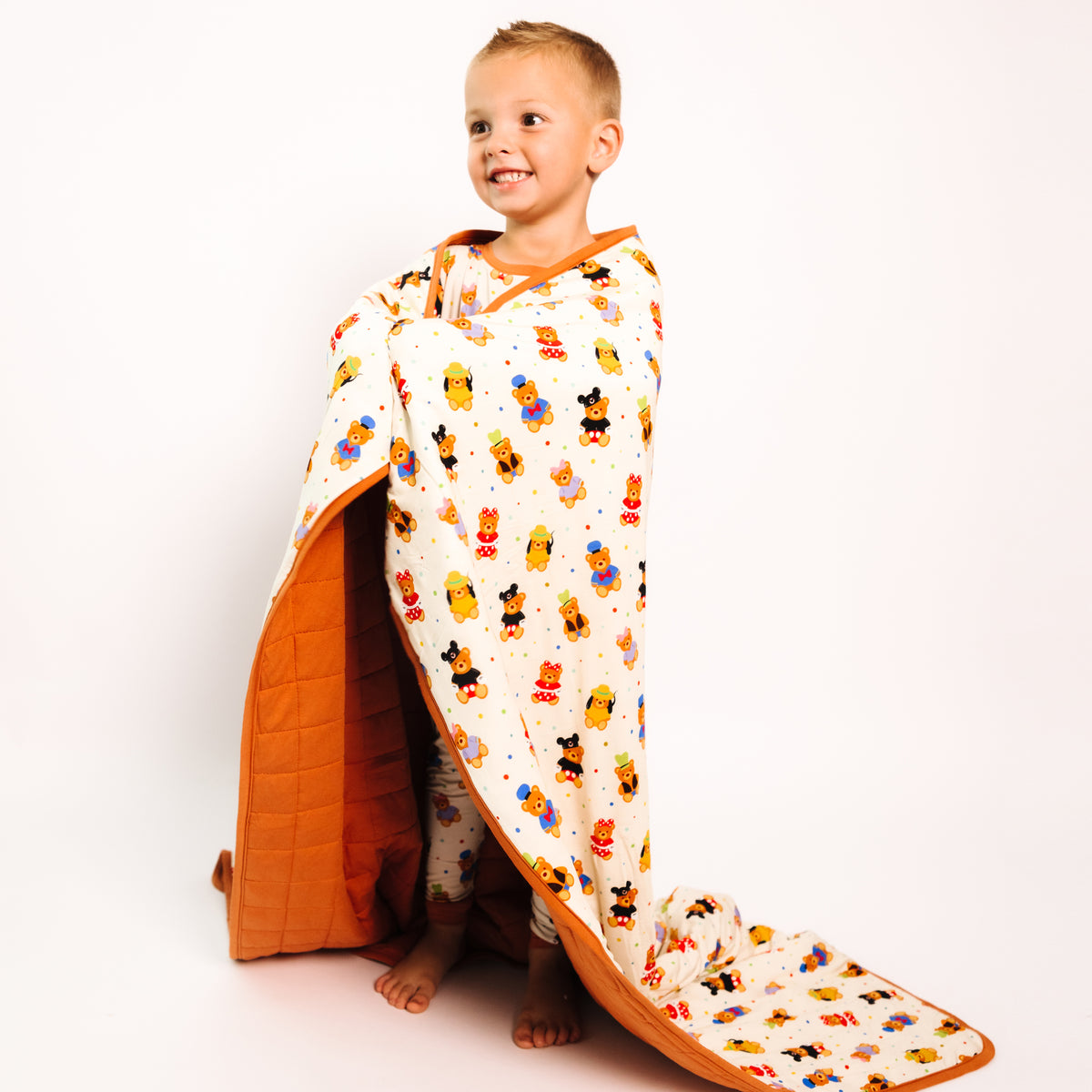 Boy wrapped in the Main Street Bears quilted bamboo kids blanket