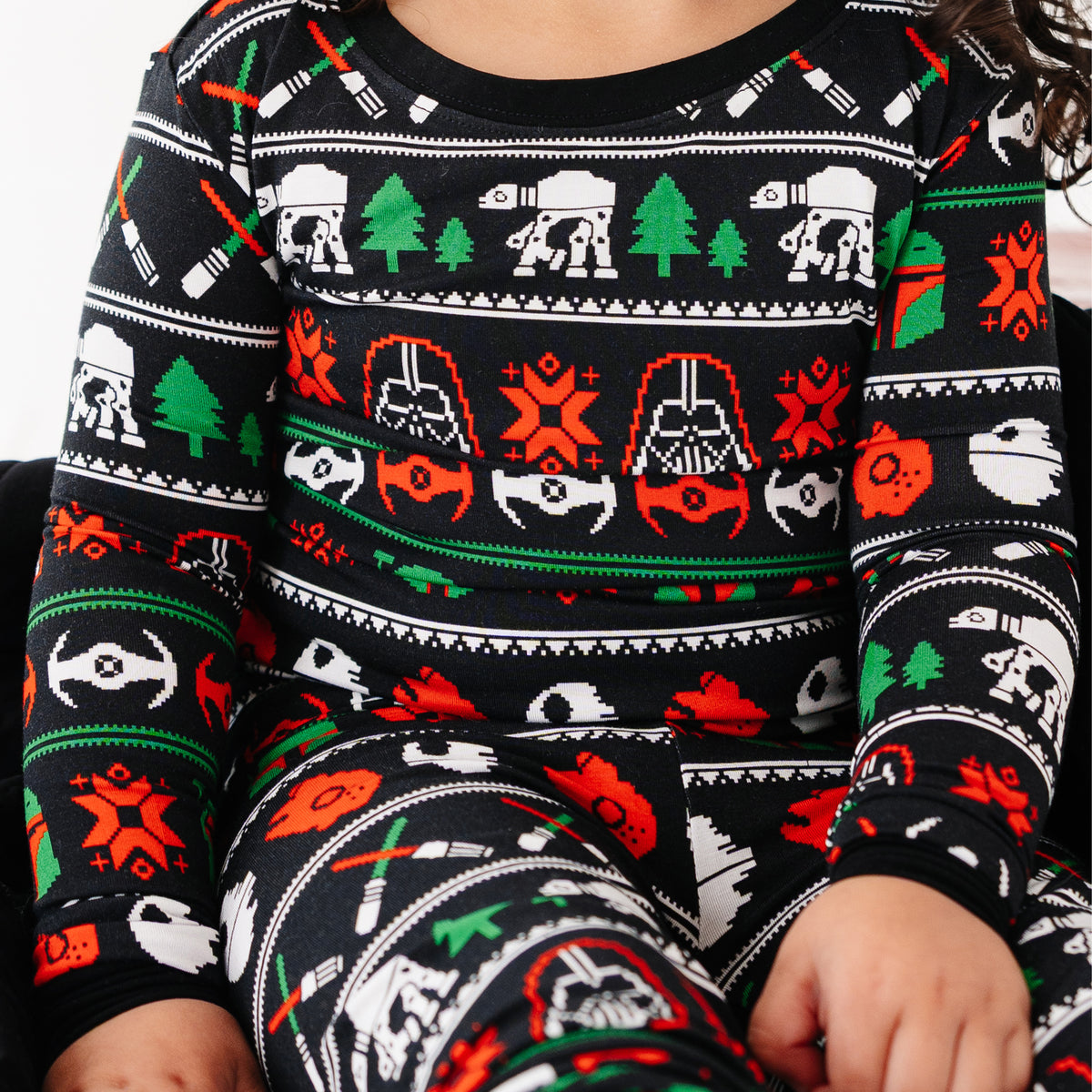 Close-up of the Merry Galaxy pajama top with a black holiday sweater print