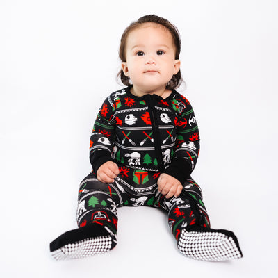 Baby sitting in the Merry Galaxy bamboo convertible romper with footies folded on