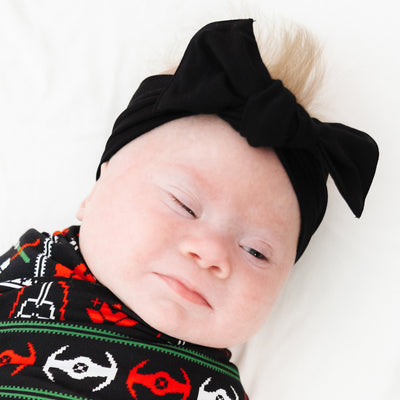 Close-up of the oversized knotted Black Bow Headband on a baby