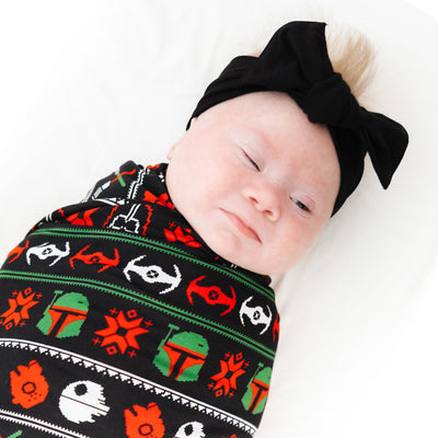 Baby swaddled in the stretchy Merry Galaxy bamboo swaddle