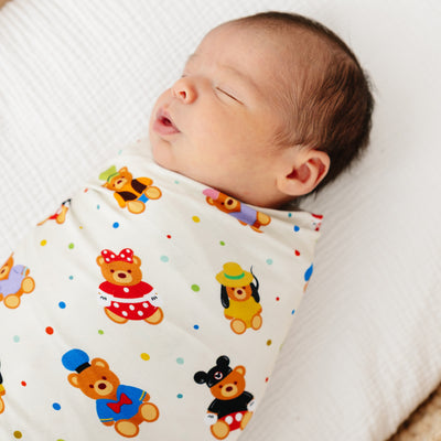 Sleeping newborn swaddled in the stretchy Main Street Bears bamboo swaddle