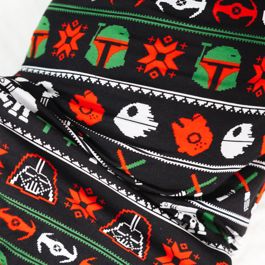 Close-up of the Merry Galaxy swaddle print with starships and snowflakes