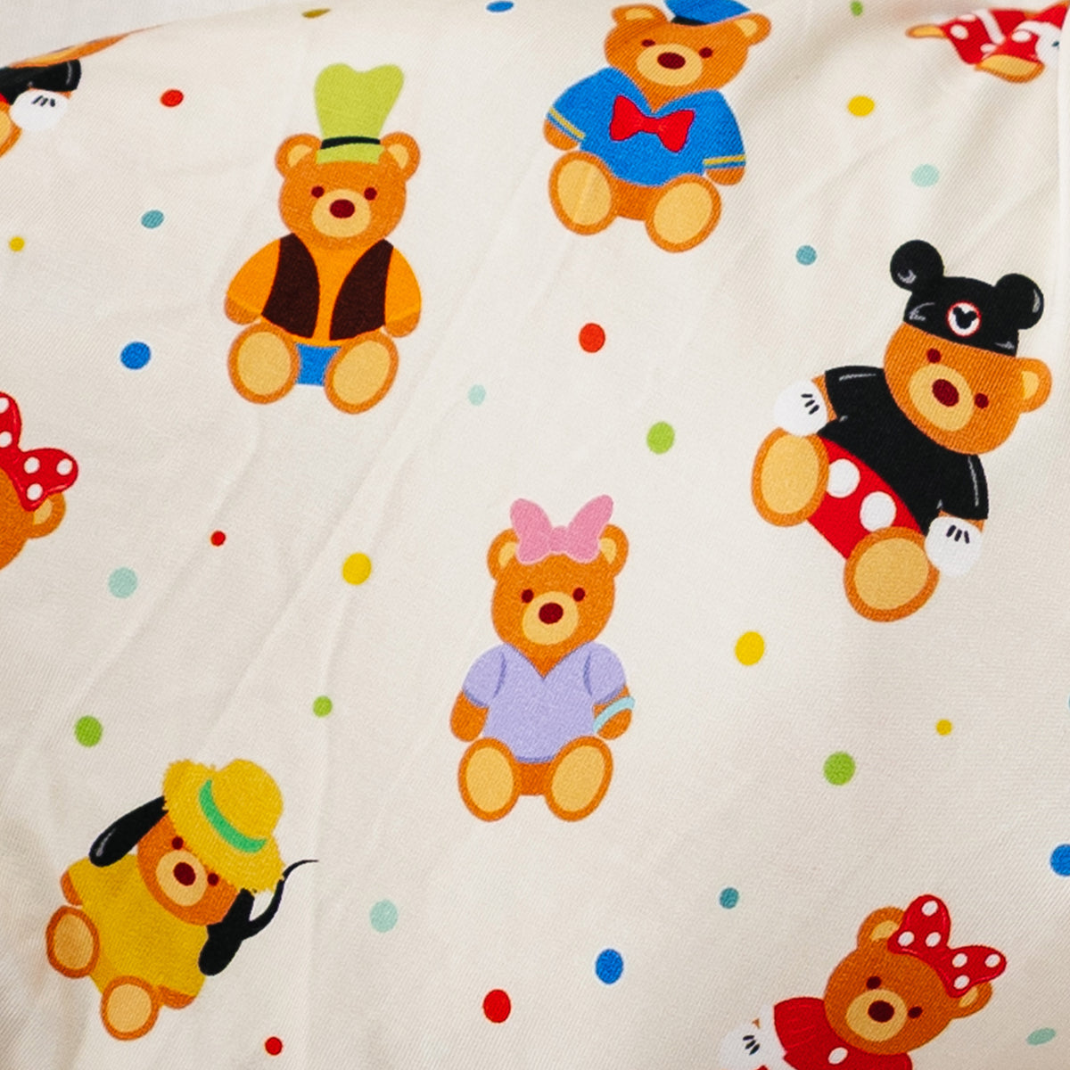 Close-up of the Main Street Bears swaddle print with teddy bears and confetti dots